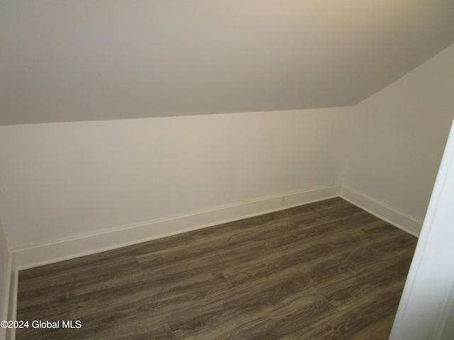 bonus room featuring dark hardwood / wood-style floors and vaulted ceiling