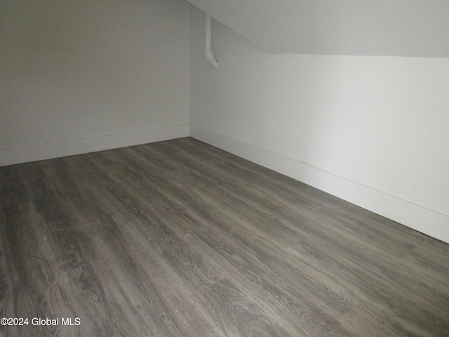 empty room featuring lofted ceiling and dark hardwood / wood-style floors