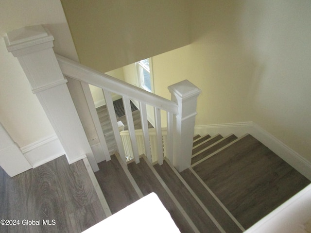 stairs featuring hardwood / wood-style floors