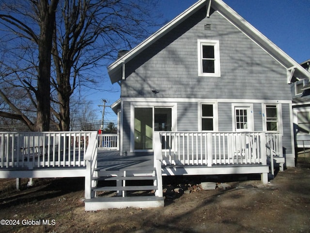 back of property featuring a wooden deck