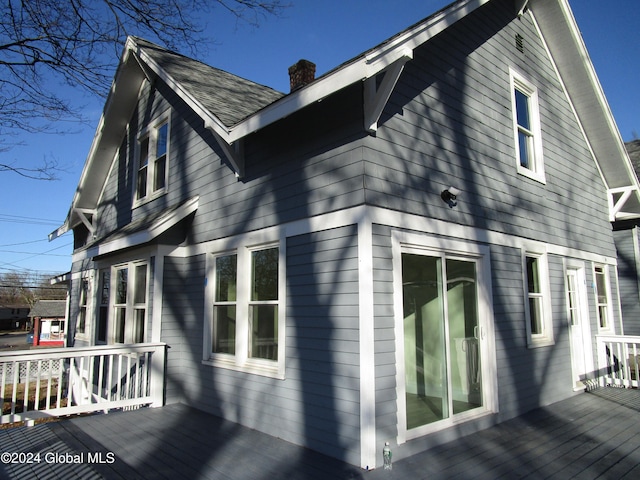 view of property exterior with a deck