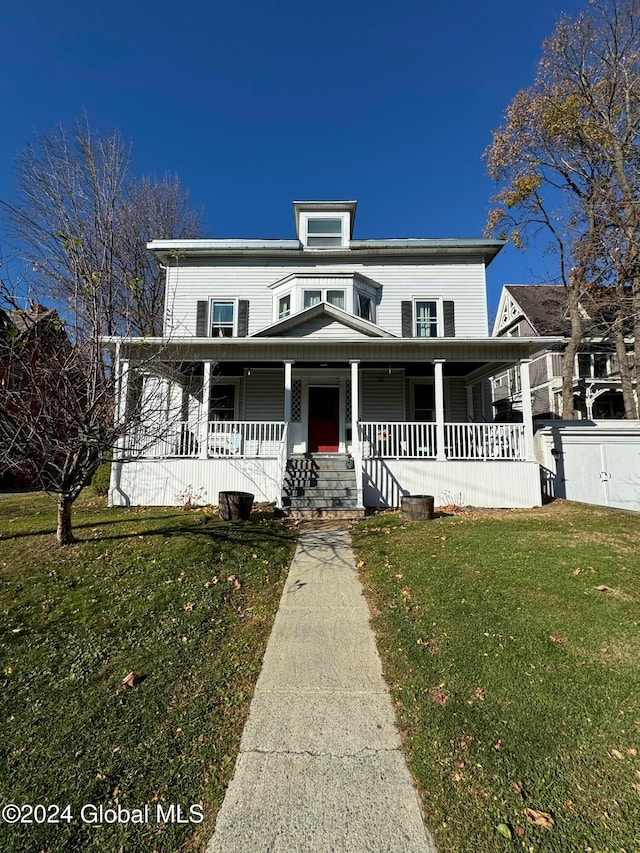 view of front of property featuring covered porch and a front yard