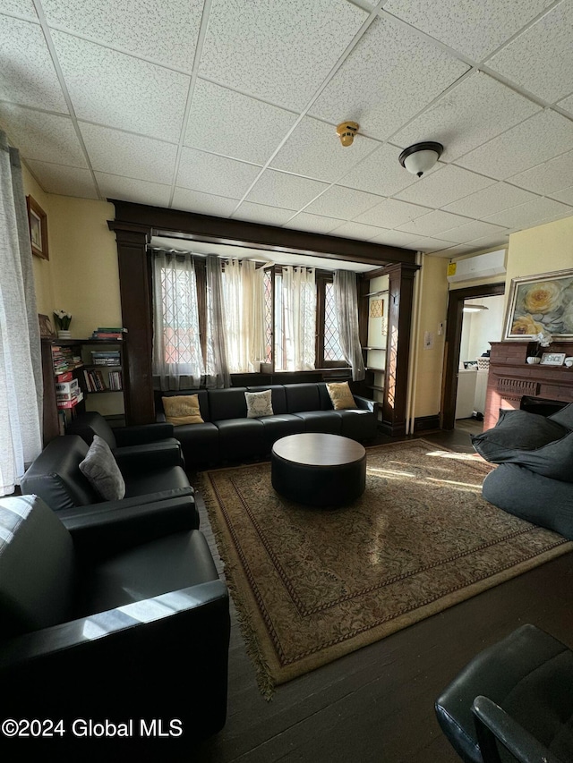 living room featuring a paneled ceiling