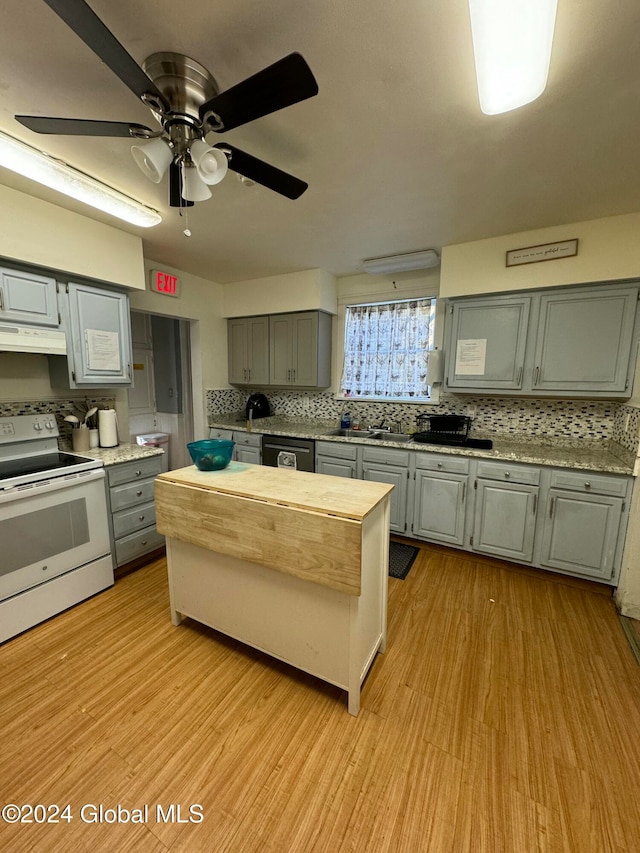 kitchen with backsplash, light hardwood / wood-style flooring, and white electric stove