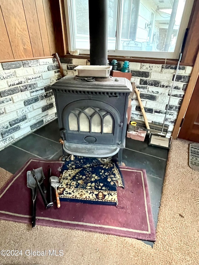 interior details featuring a wood stove and carpet floors