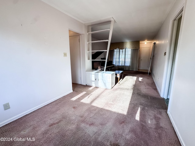 unfurnished living room featuring carpet floors