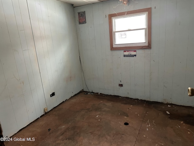 empty room featuring wood walls