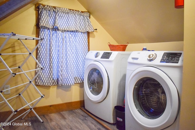 laundry area with hardwood / wood-style flooring and washing machine and dryer