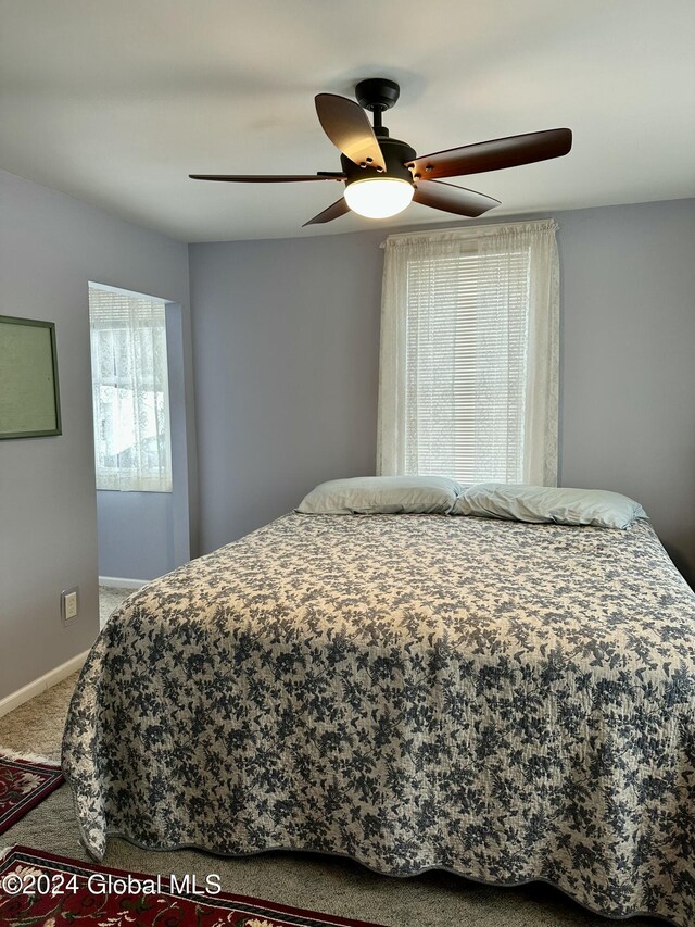 carpeted bedroom with ceiling fan