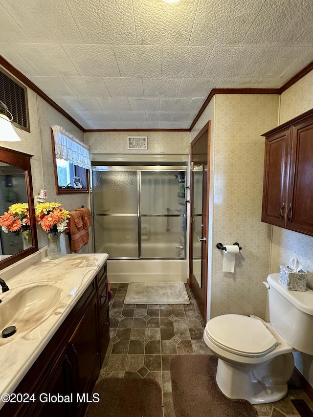 full bathroom with vanity, toilet, combined bath / shower with glass door, and crown molding