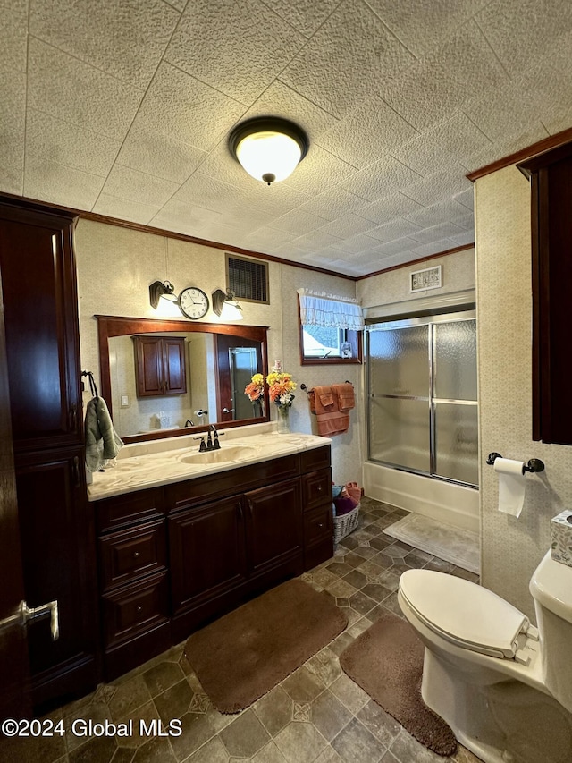 full bathroom featuring vanity, toilet, and enclosed tub / shower combo