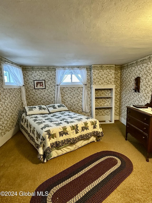 carpeted bedroom with a textured ceiling