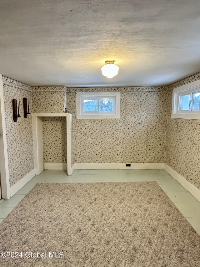 basement with a textured ceiling and plenty of natural light