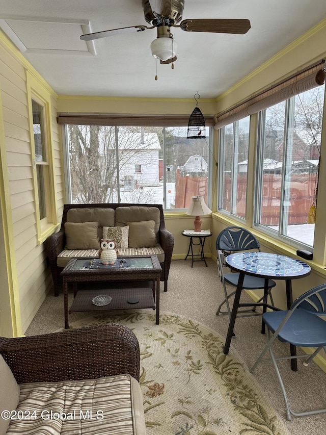 sunroom / solarium featuring ceiling fan