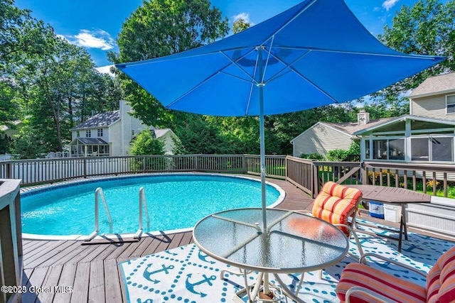 view of swimming pool with a wooden deck