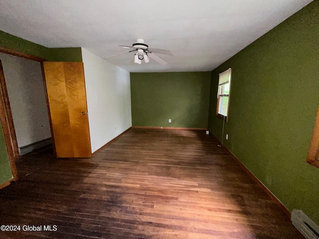 unfurnished room with dark hardwood / wood-style flooring and ceiling fan