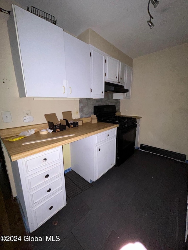 kitchen with white cabinets, black range with gas stovetop, and backsplash