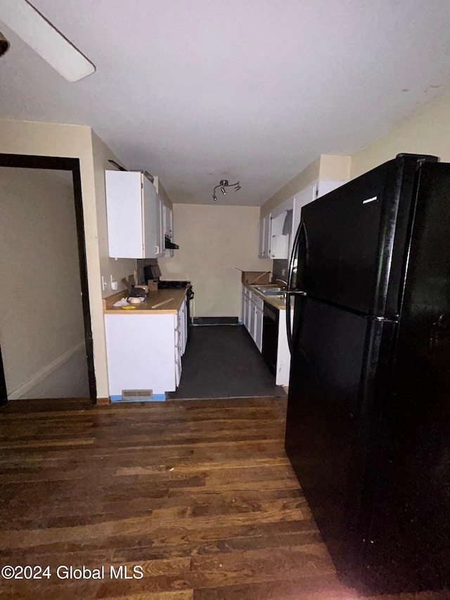 kitchen featuring white cabinetry, black appliances, and dark hardwood / wood-style floors