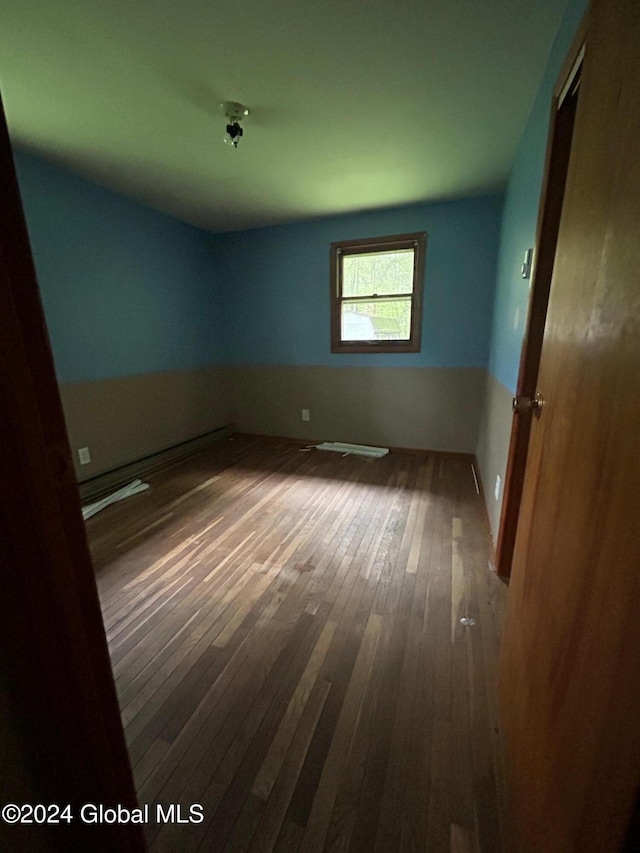 spare room featuring hardwood / wood-style flooring