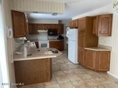 kitchen with kitchen peninsula, white appliances, and exhaust hood