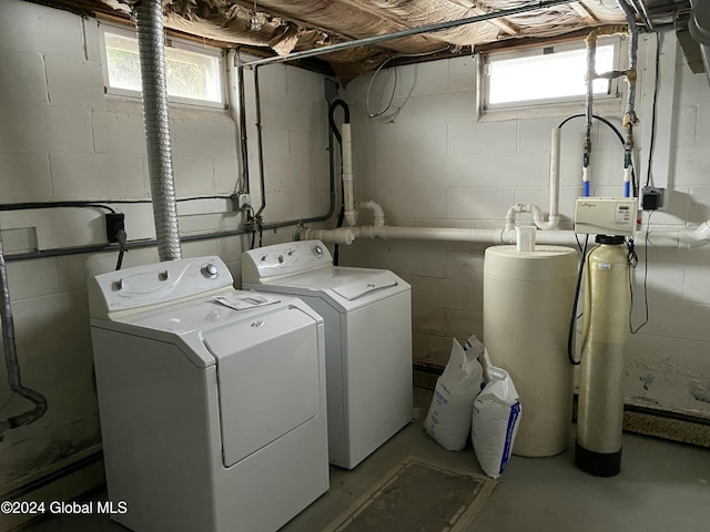 clothes washing area with washing machine and clothes dryer and plenty of natural light