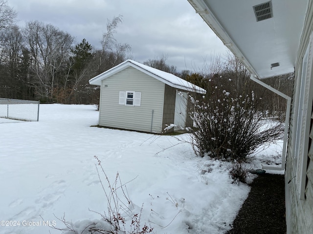 view of snow covered exterior with an outbuilding