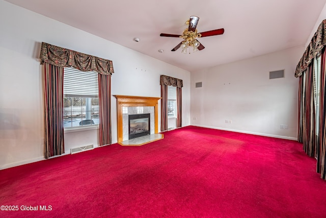 unfurnished living room featuring carpet flooring, ceiling fan, and a fireplace