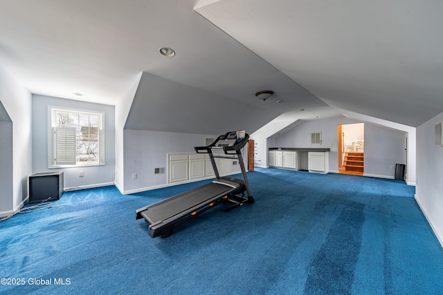 workout area with carpet floors and vaulted ceiling