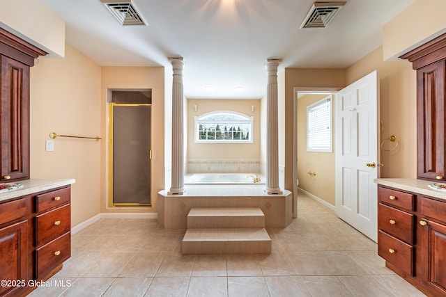 full bathroom with ornate columns, tile patterned flooring, plus walk in shower, and toilet