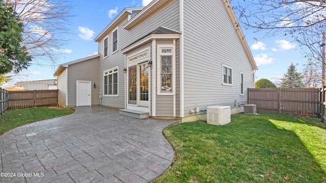 back of property featuring a patio area, a yard, and cooling unit