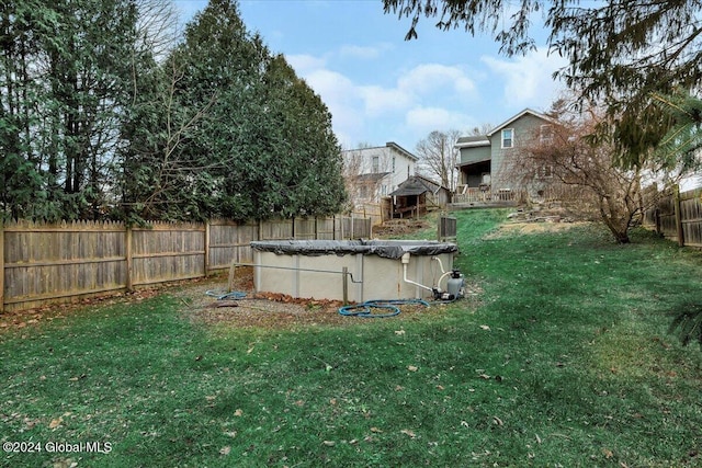 view of yard featuring a covered pool