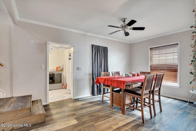 dining room featuring washer / dryer, hardwood / wood-style flooring, ceiling fan, and crown molding