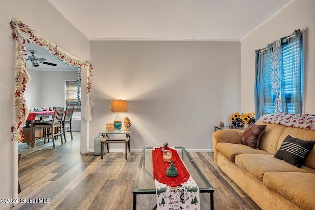 living room featuring hardwood / wood-style floors, plenty of natural light, ceiling fan, and ornamental molding