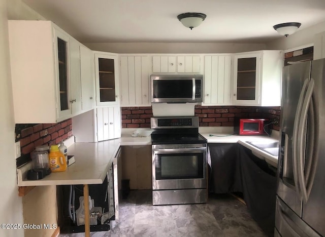 24 Wagner St, Fort Plain, NY 13339 - kitchen featuring stainless steel appliances, light countertops, white cabinetry, and tasteful backsplash