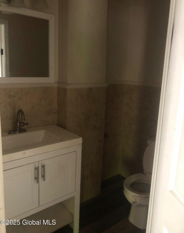 24 Wagner St, Fort Plain, NY 13339 - bathroom with vanity, tile walls, and wainscoting
