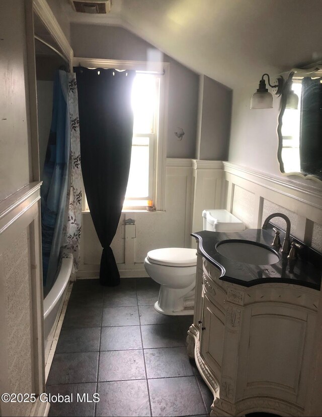 24 Wagner St, Fort Plain, NY 13339 - bathroom featuring vanity, vaulted ceiling, shower / bath combo, and wainscoting