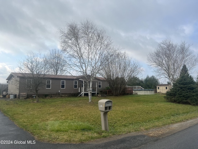 238 Mcewan Rd, Canajoharie, NY 13317 - manufactured / mobile home featuring a wooden deck and a front lawn