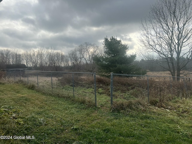 view of yard featuring a rural view and fence