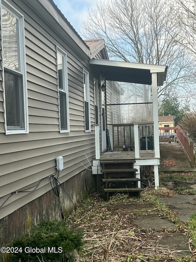 view of side of property with a wooden deck