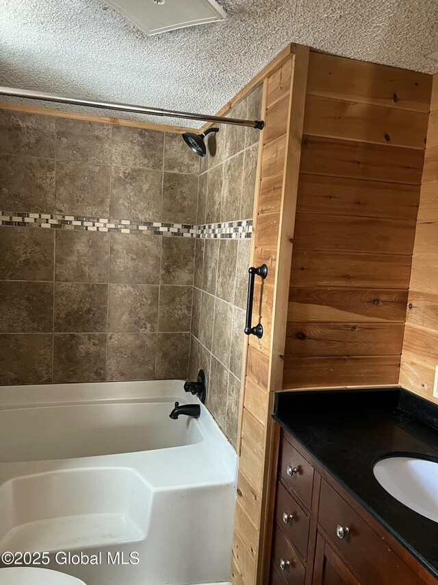 full bathroom with vanity, tub / shower combination, and a textured ceiling