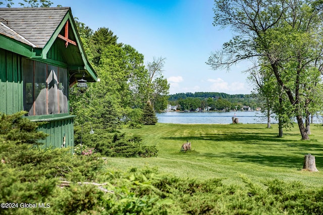 exterior space with a water view and a yard