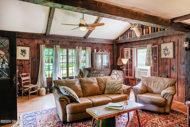 living room featuring ceiling fan, vaulted ceiling with beams, wood walls, cooling unit, and hardwood / wood-style flooring