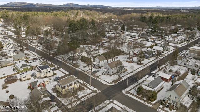 snowy aerial view with a mountain view