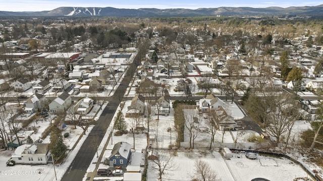 snowy aerial view featuring a mountain view