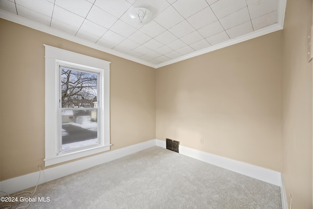 carpeted empty room with crown molding