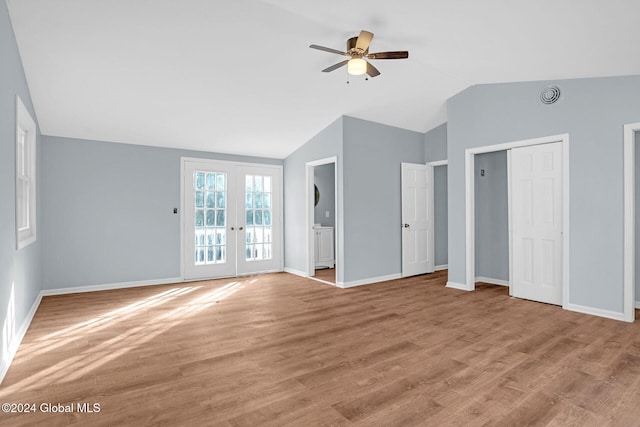 unfurnished living room featuring ceiling fan, vaulted ceiling, french doors, and light hardwood / wood-style flooring