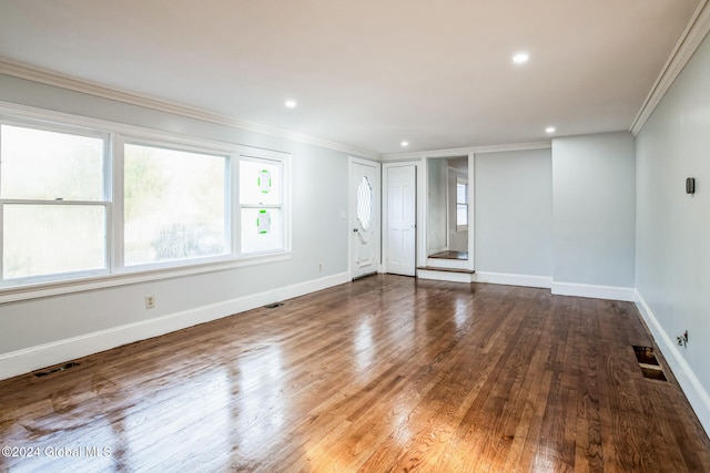 unfurnished room featuring hardwood / wood-style floors and crown molding