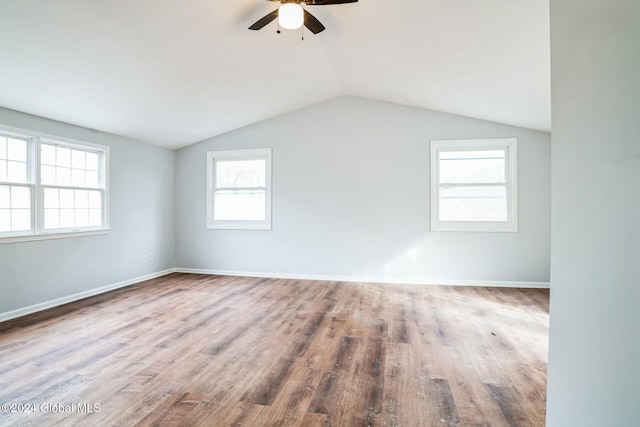 bonus room featuring a healthy amount of sunlight, lofted ceiling, and hardwood / wood-style flooring