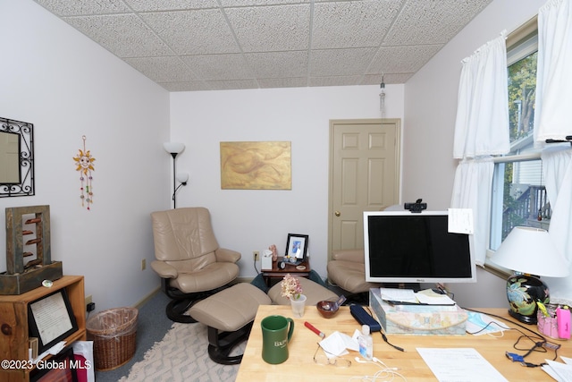 office space with a paneled ceiling and carpet floors