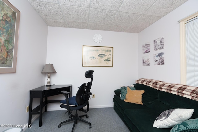 carpeted home office featuring a paneled ceiling